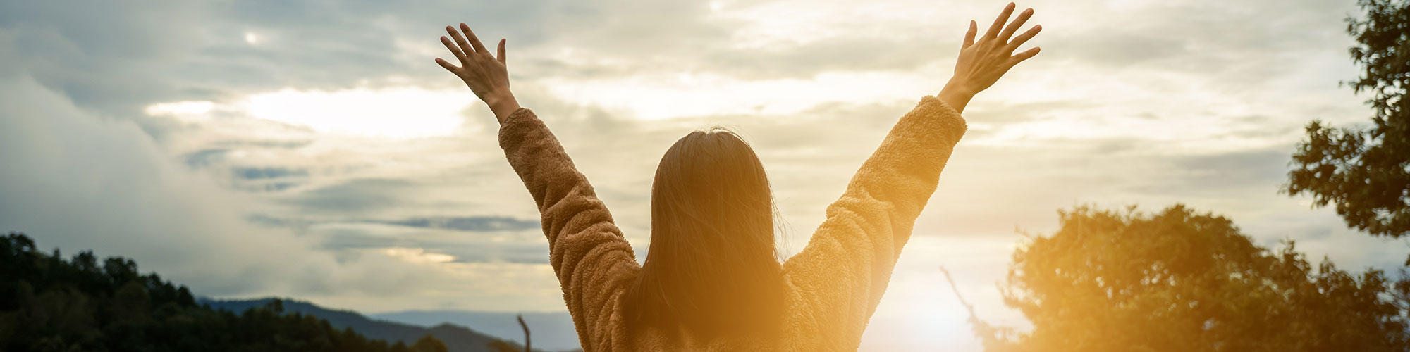 Woman Raising Arms Sunrise